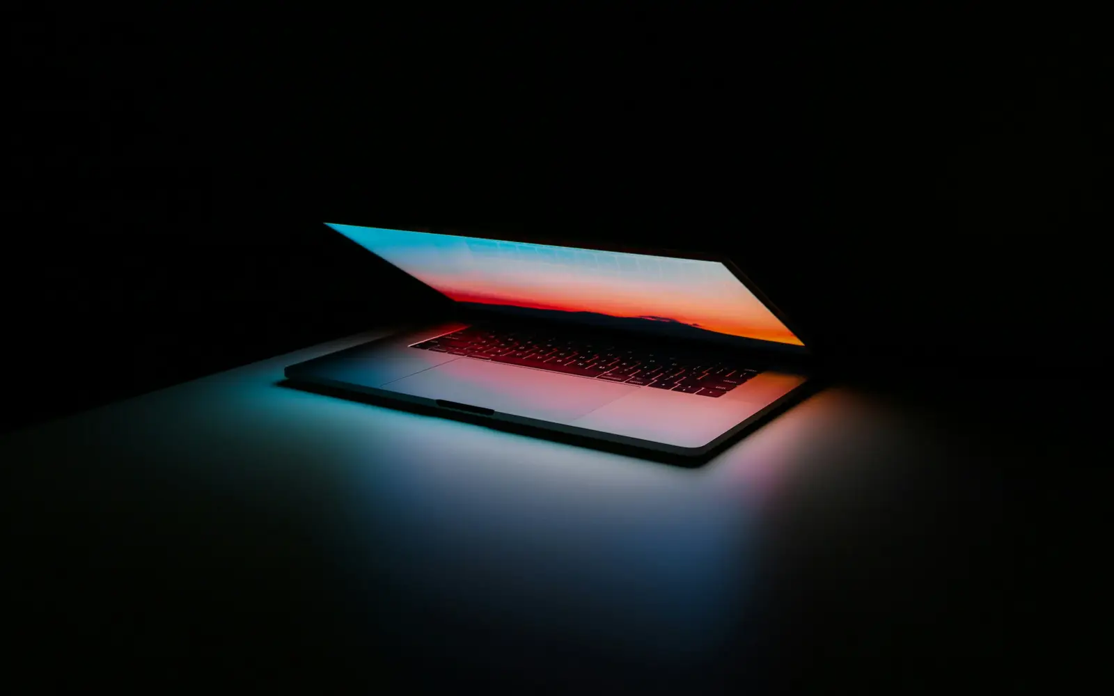A laptop glowing in the dark